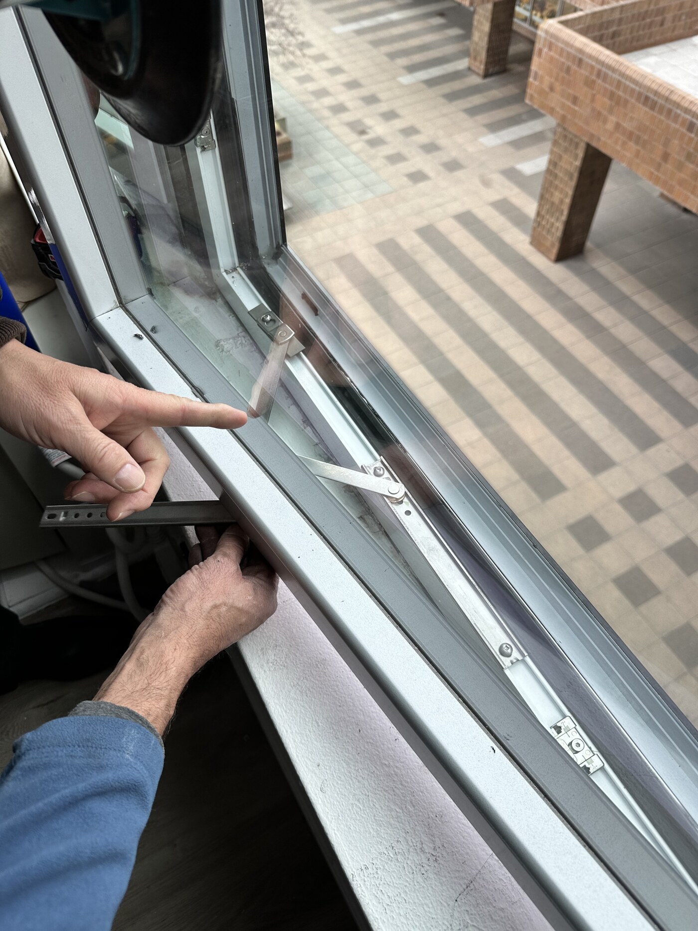 Close-up of a new window operator and hardware during installation