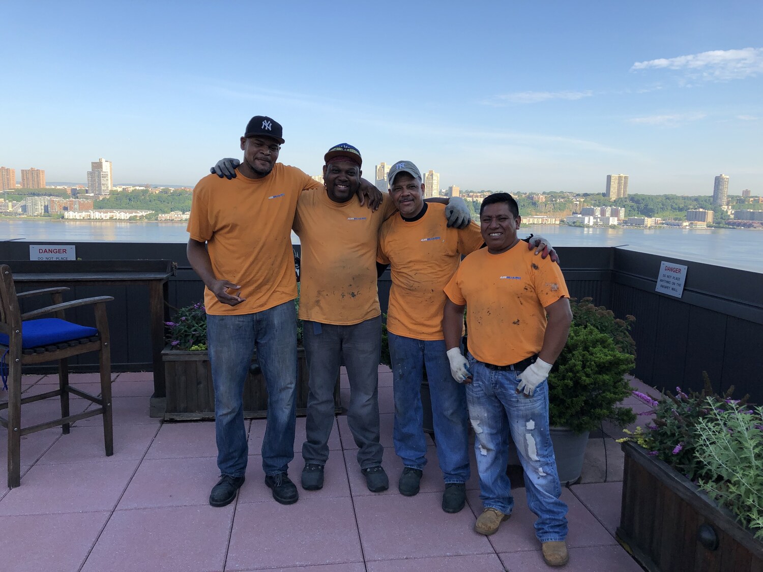 The AirGuard installation crew on a rooftop overlooking the Hudson River